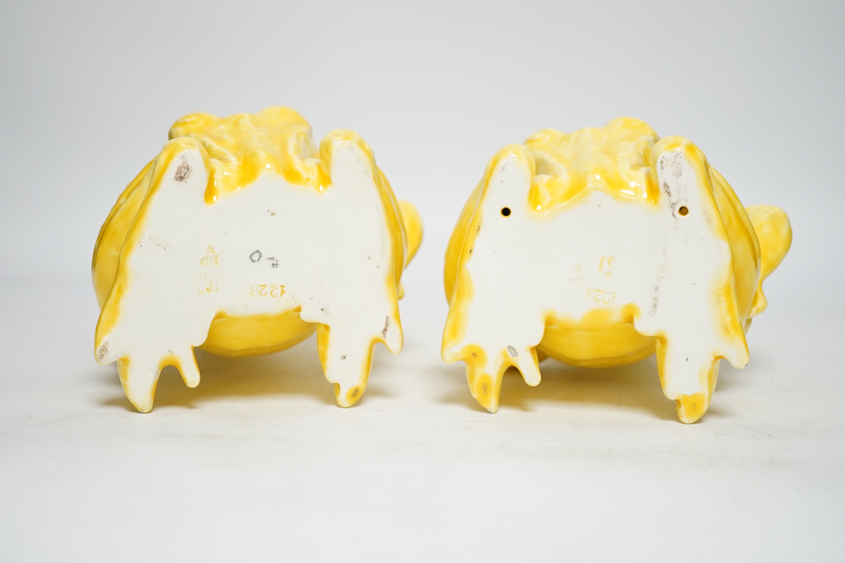 A pair of Continental yellow glazed pottery frogs, 21.5cm